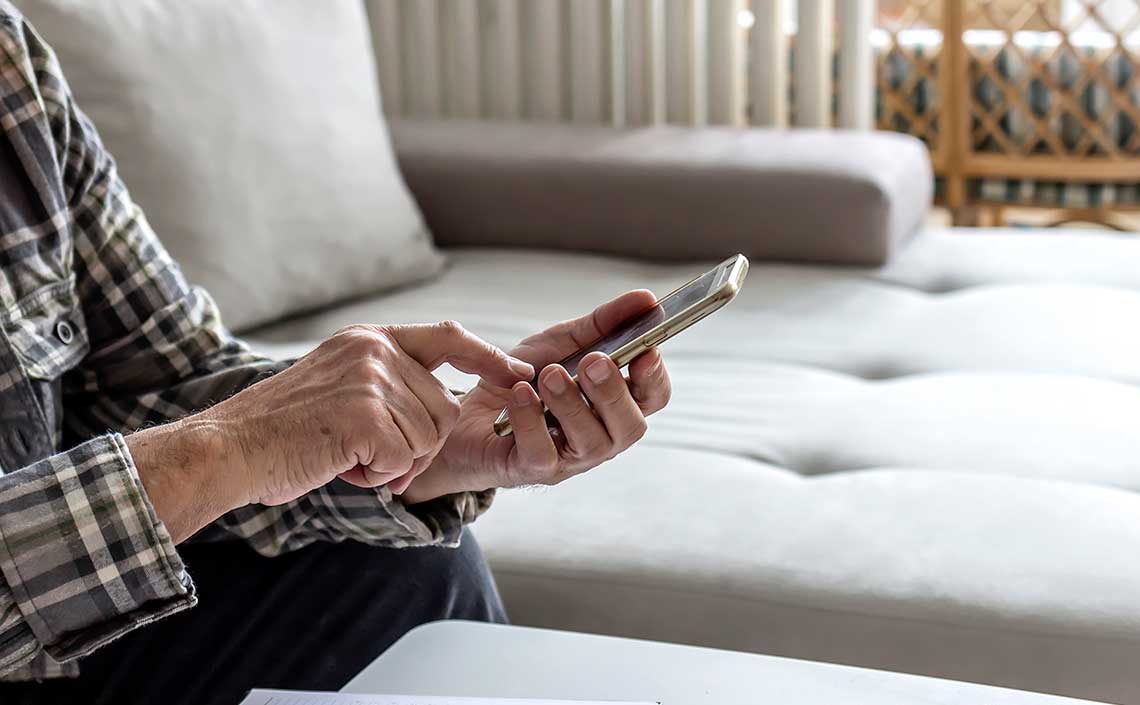 an older man using an iPhone